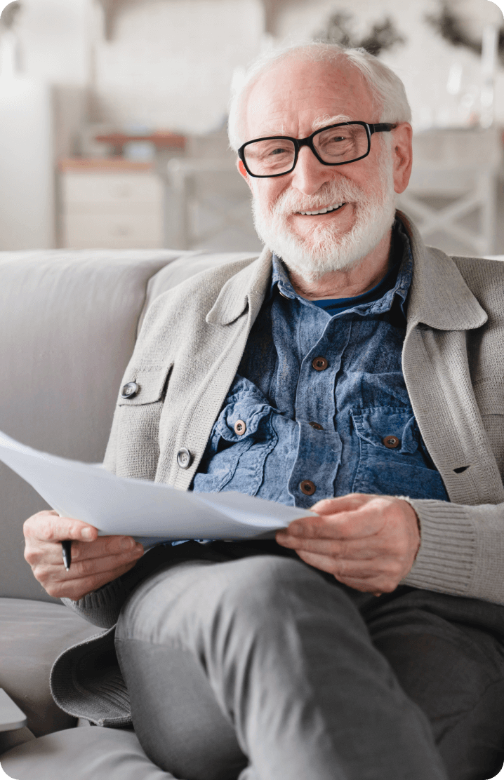 An old man smiling by looking at ease of loan process